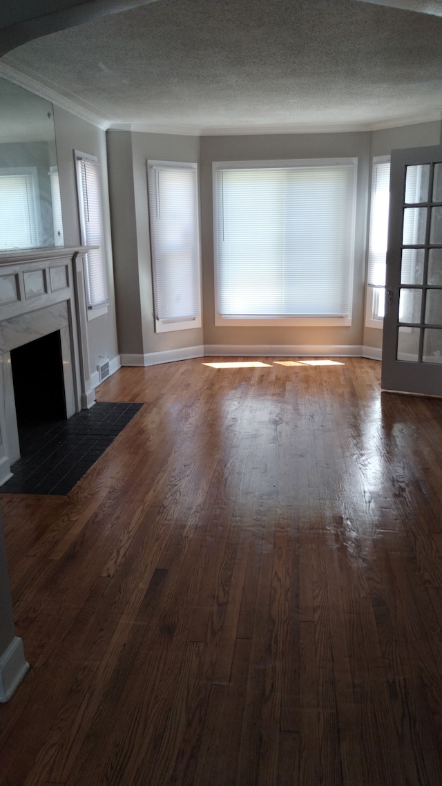 unfurnished living room with a textured ceiling and hardwood / wood-style flooring