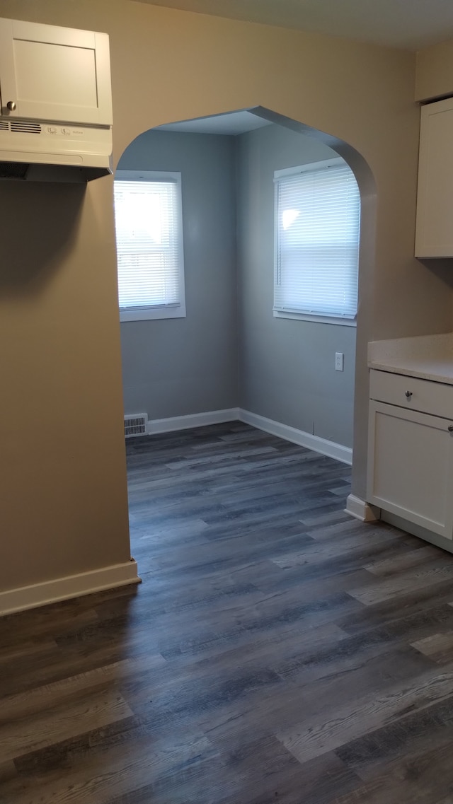 unfurnished dining area with dark hardwood / wood-style floors