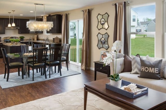 dining area with a notable chandelier and dark wood-type flooring