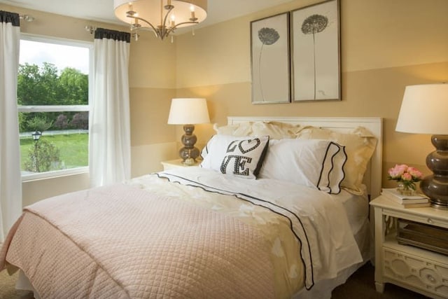 bedroom with multiple windows and an inviting chandelier