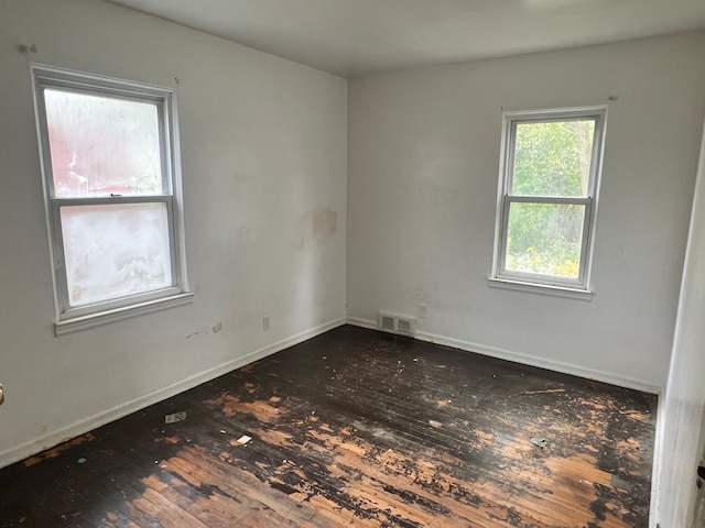 unfurnished room featuring dark hardwood / wood-style floors