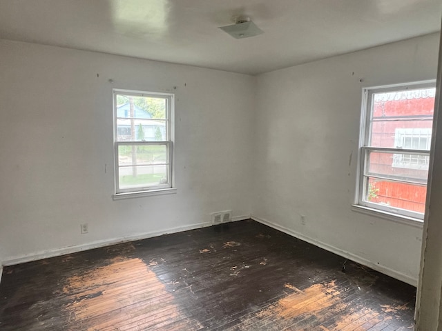 spare room featuring dark hardwood / wood-style floors