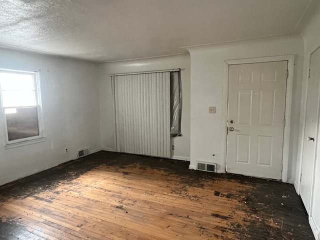 interior space featuring dark hardwood / wood-style flooring and a textured ceiling