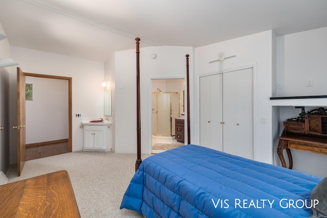 carpeted bedroom with sink, connected bathroom, and a closet