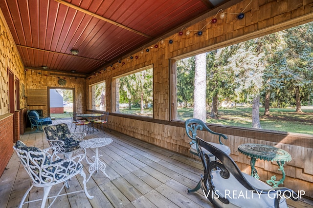 sunroom / solarium featuring wood ceiling