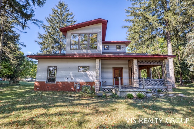 view of front of house with a front yard and a porch