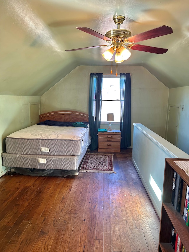 unfurnished bedroom with hardwood / wood-style flooring, ceiling fan, and vaulted ceiling