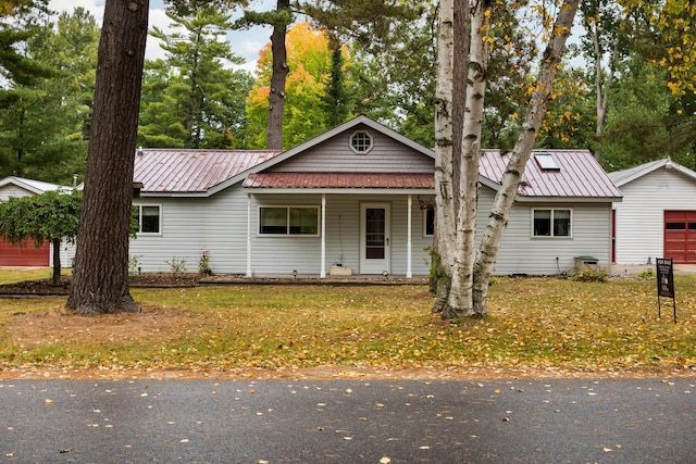 view of front of property featuring an outdoor structure, a porch, and a garage