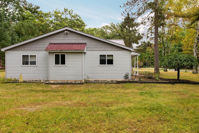 1758 W Nestel Rd, Prudenville, MI 48651 - rear view of property featuring a lawn and metal roof