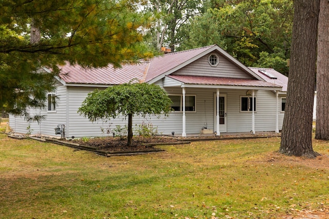 1758 W Nestel Rd, Prudenville, MI 48651 - ranch-style home featuring a front lawn, metal roof, and covered porch