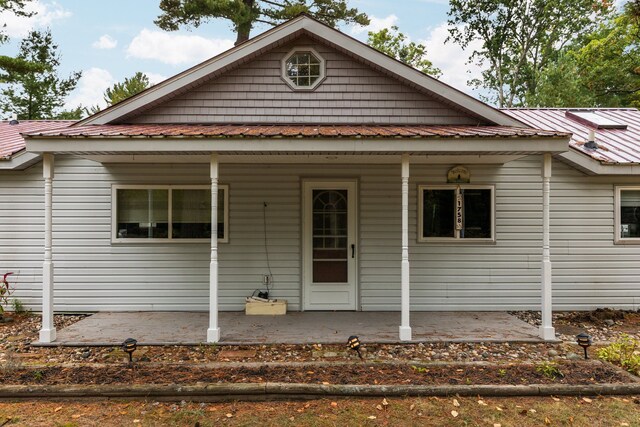 1758 W Nestel Rd, Prudenville, MI 48651 - view of front of property with covered porch and metal roof