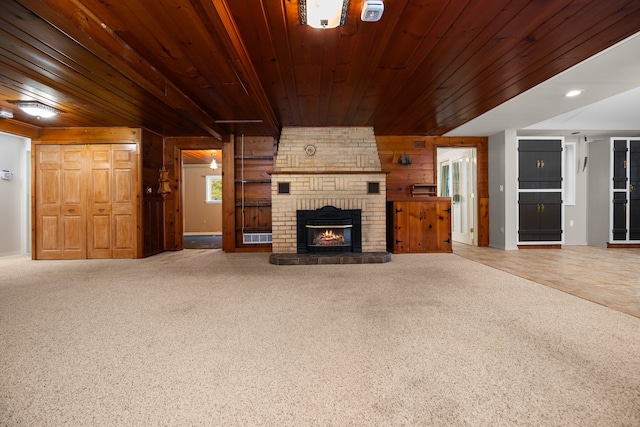 unfurnished living room with carpet floors and wood ceiling