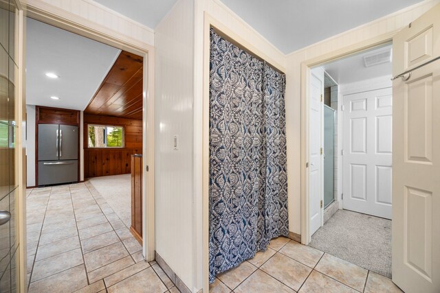 1758 W Nestel Rd, Prudenville, MI 48651 - bathroom featuring tile patterned flooring, a shower, wooden walls, recessed lighting, and baseboards
