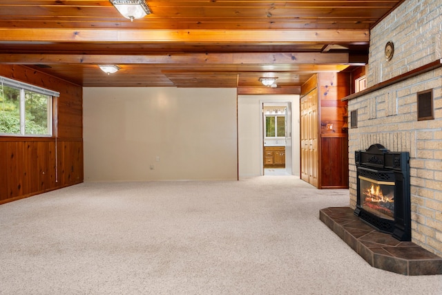 living room featuring carpet, wooden ceiling, and wooden walls