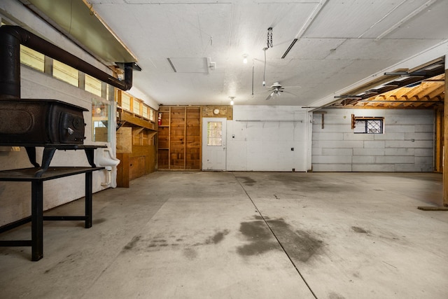 garage featuring a wood stove and ceiling fan