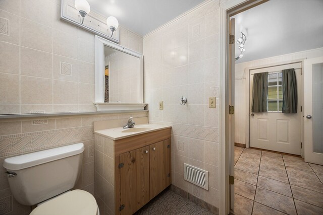 1758 W Nestel Rd, Prudenville, MI 48651 - bathroom featuring tile walls, vanity, and toilet