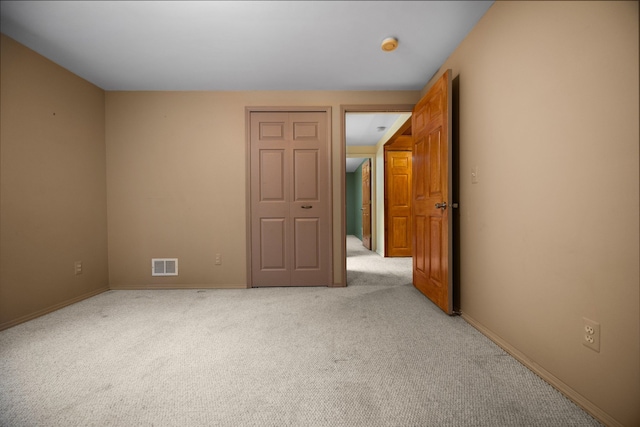 empty room featuring light carpet