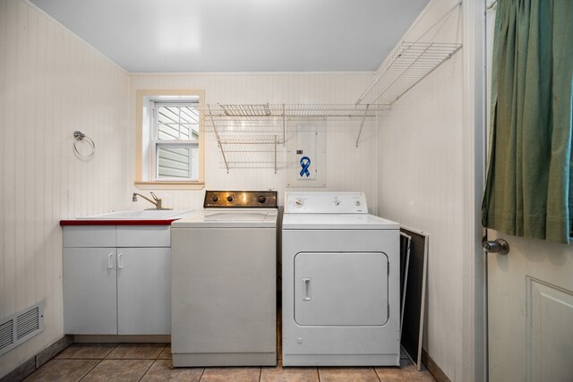 1758 W Nestel Rd, Prudenville, MI 48651 - laundry area with separate washer and dryer, light tile patterned flooring, and cabinet space