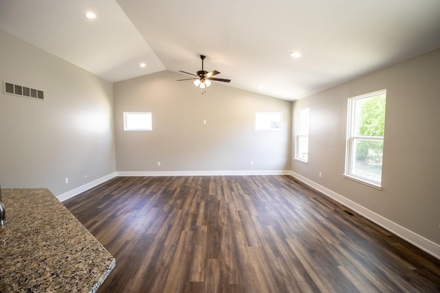 unfurnished living room with ceiling fan, dark wood-type flooring, and vaulted ceiling