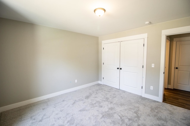 unfurnished bedroom featuring carpet flooring and a closet