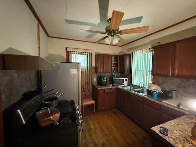 kitchen with sink, dark hardwood / wood-style floors, backsplash, black gas stove, and ornamental molding