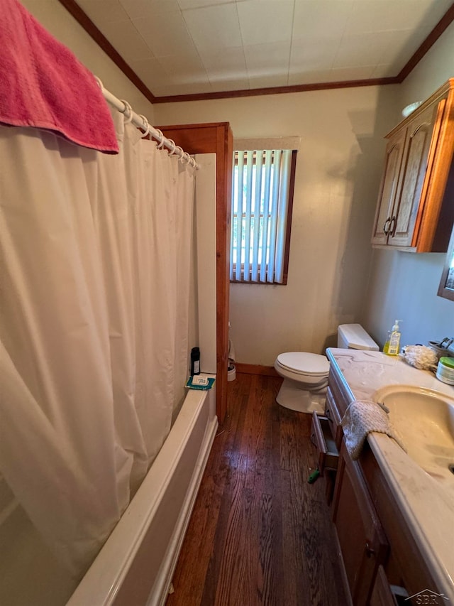 full bathroom with hardwood / wood-style floors, toilet, vanity, shower / tub combo, and ornamental molding