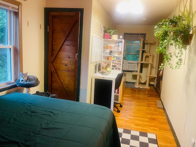 bedroom featuring light hardwood / wood-style floors and cooling unit