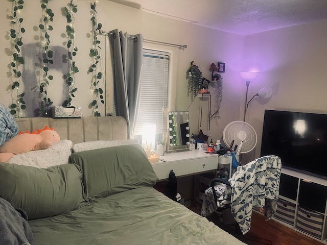 bedroom featuring a textured ceiling and hardwood / wood-style flooring