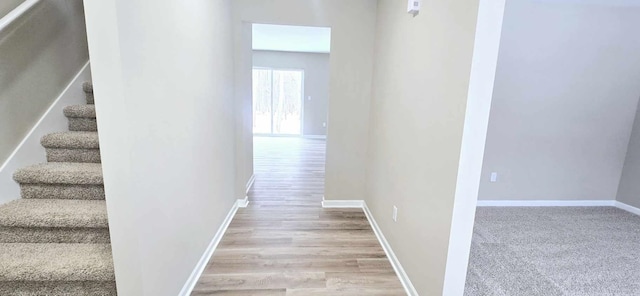 corridor with light hardwood / wood-style floors