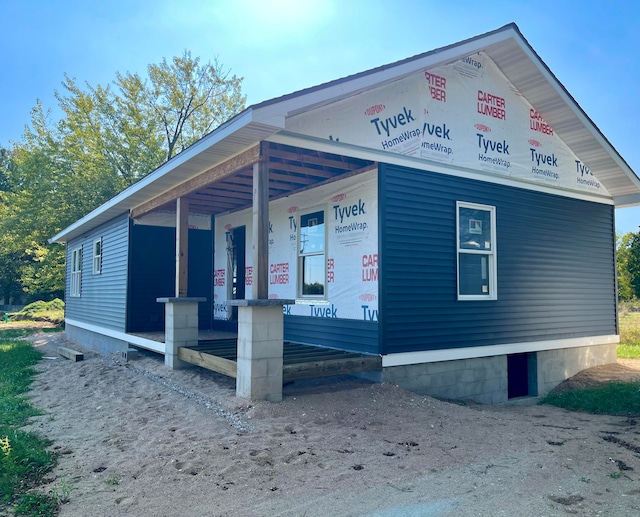 view of side of home with a porch