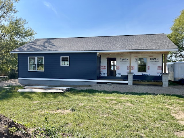 6193 S Pere Marquette Hwy, Pentwater, MI 49449 - view of front of property with a front lawn, a shingled roof, and covered porch