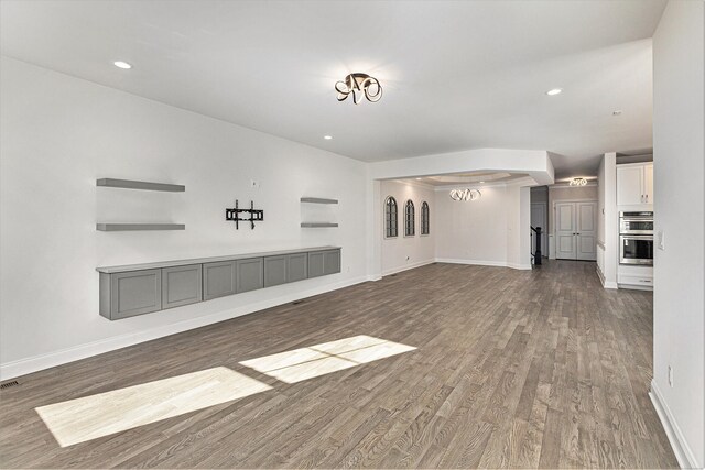 unfurnished living room featuring dark wood-type flooring