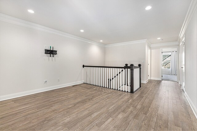 spare room with hardwood / wood-style flooring and ornamental molding