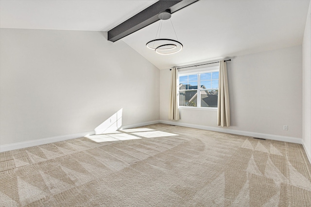 carpeted spare room with vaulted ceiling with beams