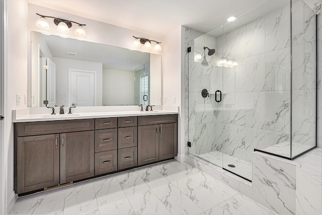 bathroom with vanity and a shower with door