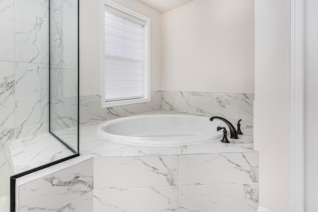 bathroom with tiled tub