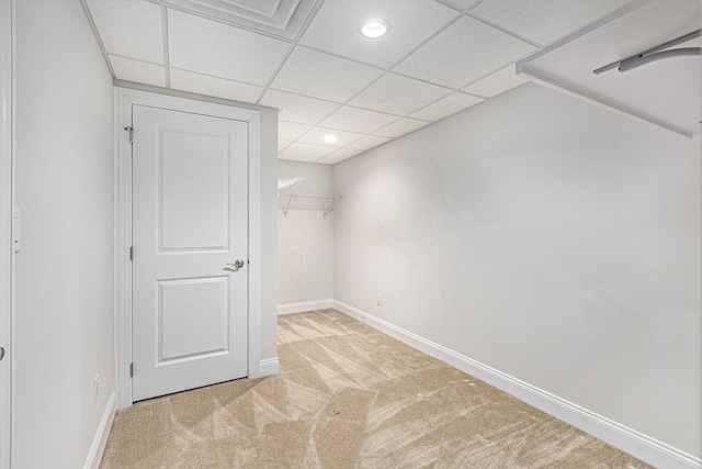 interior space with light carpet and a drop ceiling