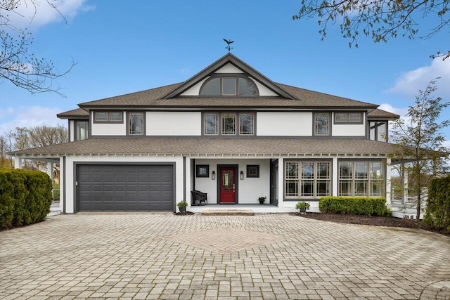 view of front of home featuring a porch and a garage