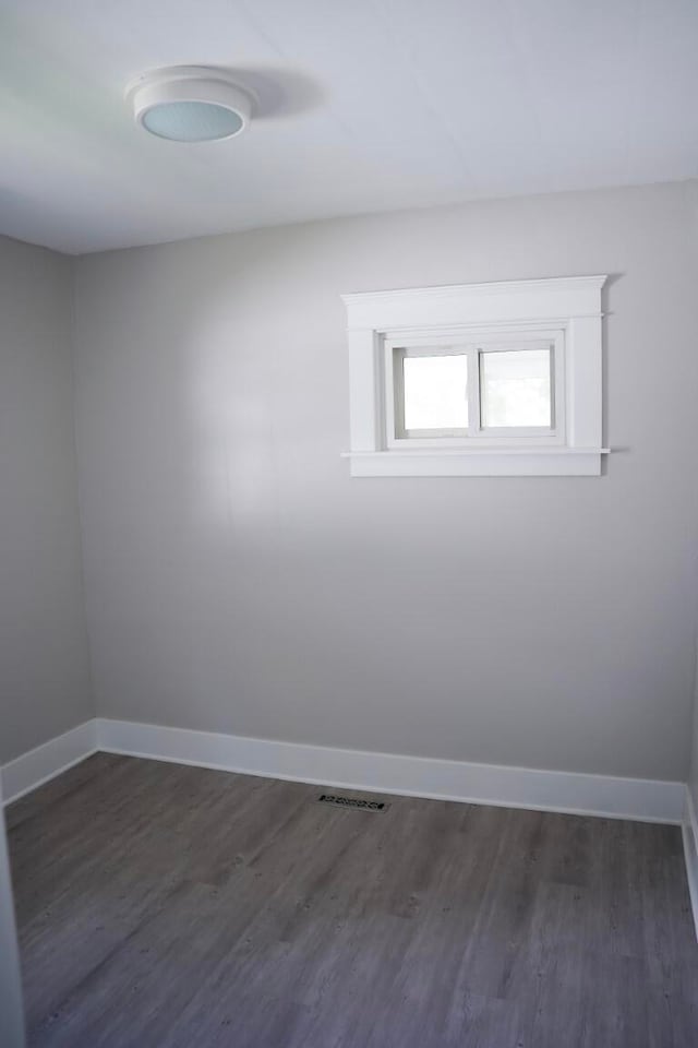 unfurnished room featuring dark hardwood / wood-style floors