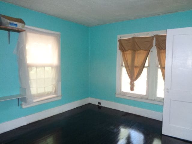 spare room with hardwood / wood-style floors