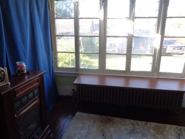 interior space with radiator and hardwood / wood-style flooring