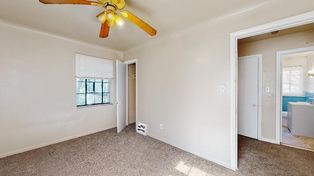 empty room featuring carpet flooring and ceiling fan