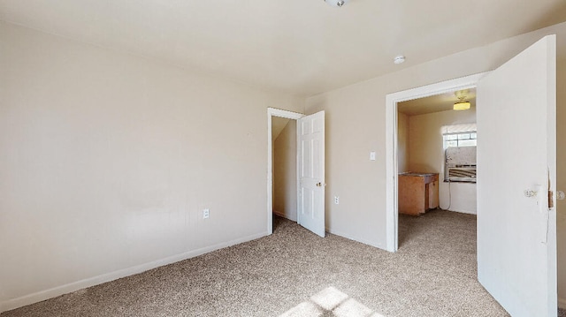 unfurnished bedroom featuring light carpet