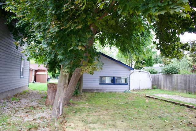 exterior space featuring a storage unit and a yard