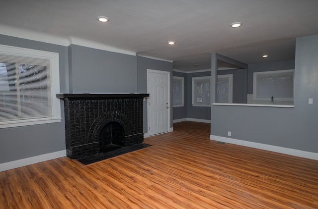 unfurnished living room with a fireplace and light hardwood / wood-style floors