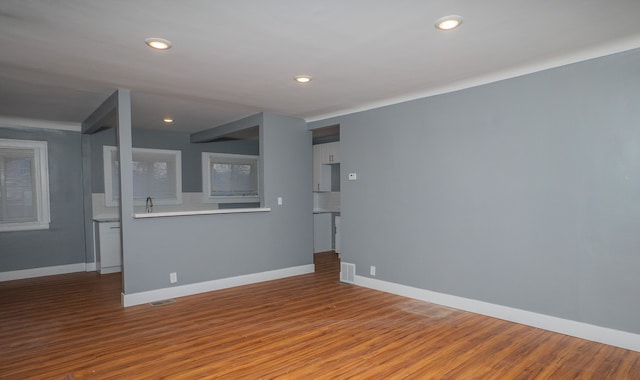 spare room featuring wood-type flooring