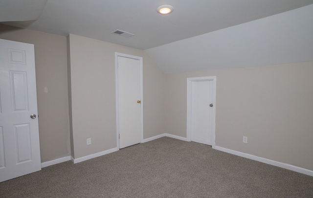 additional living space with lofted ceiling and carpet