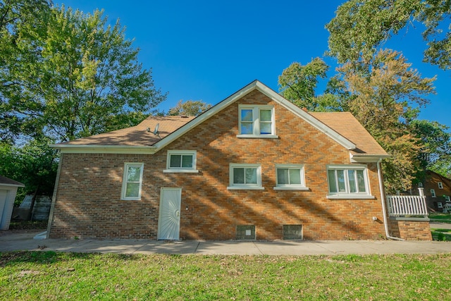 back of property featuring a lawn and a patio area