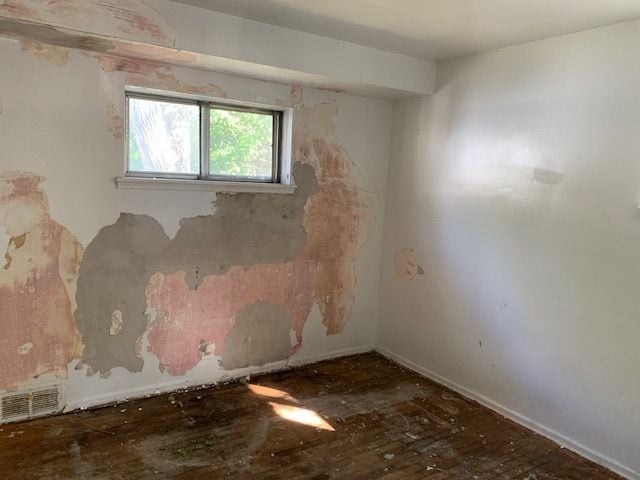 empty room featuring dark hardwood / wood-style flooring