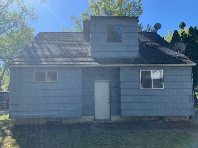 rear view of house with a lawn